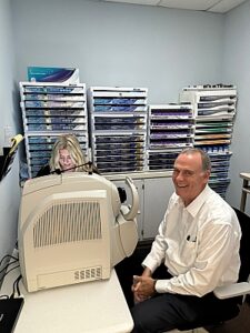 Patient and staff in optical dept.