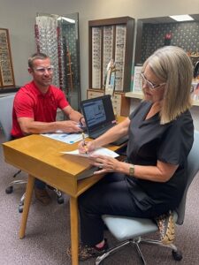 Patient being helped in Optical department.